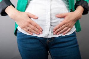 Businesswoman with abdominal pains